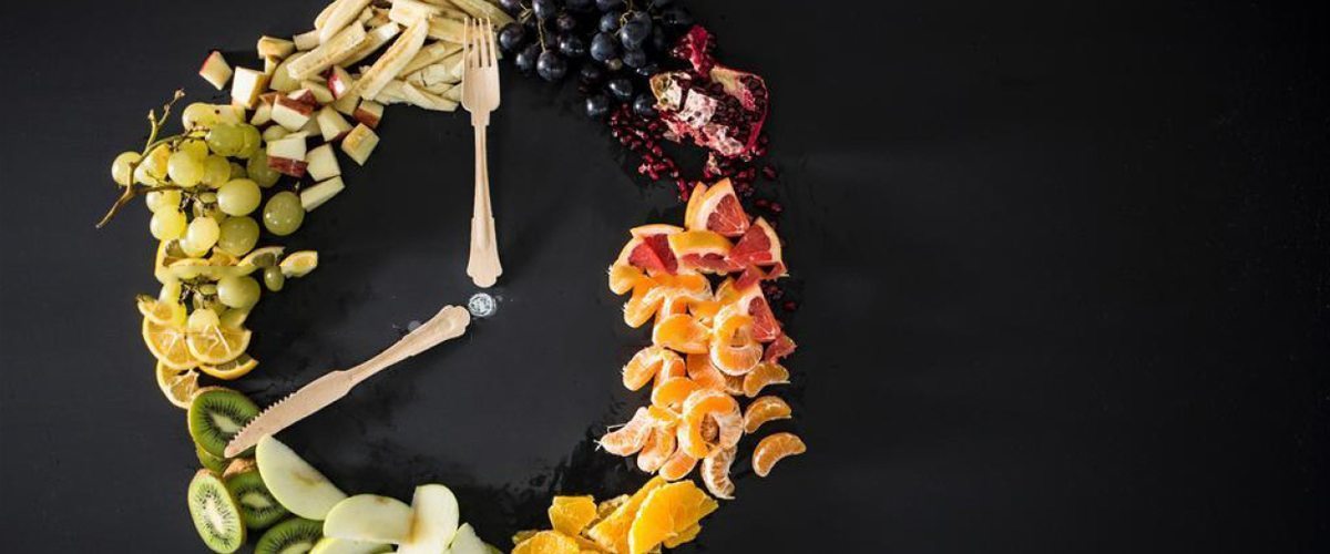 Assorted sliced fruit including grapes, apples, bananas and kiwi