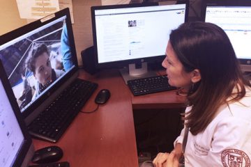 A healthcare provider speaking to a patient on-screen