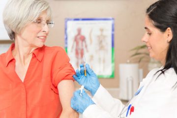 A woman receiving a shot in the arm