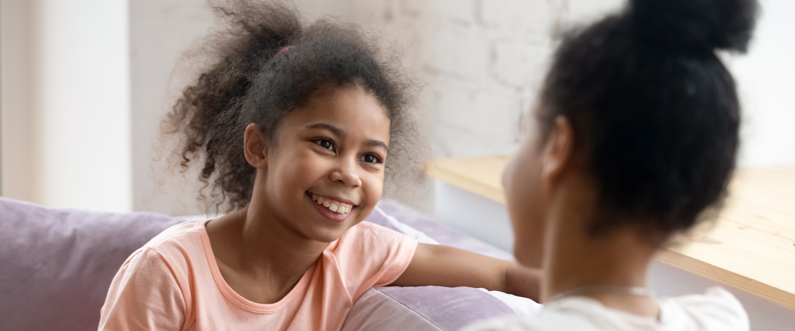 A woman speaking to a pre-teen about the HPV Vaccine